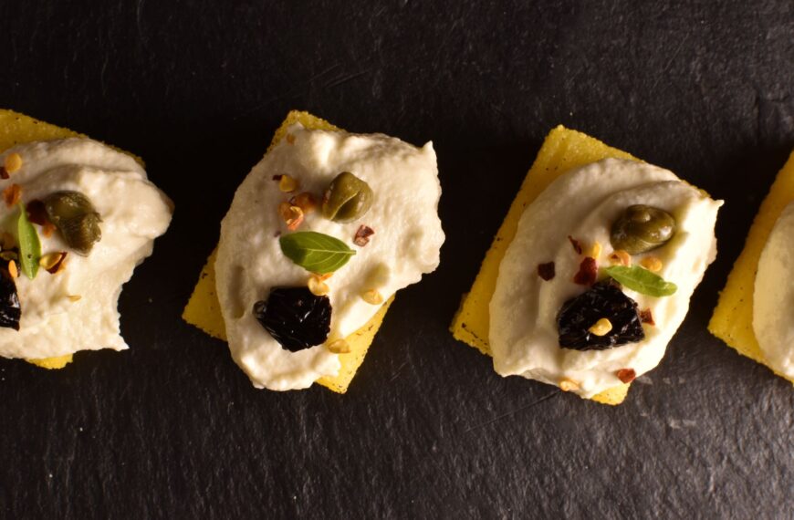 Polenta cubes, baccalà mantecato, capers and olives